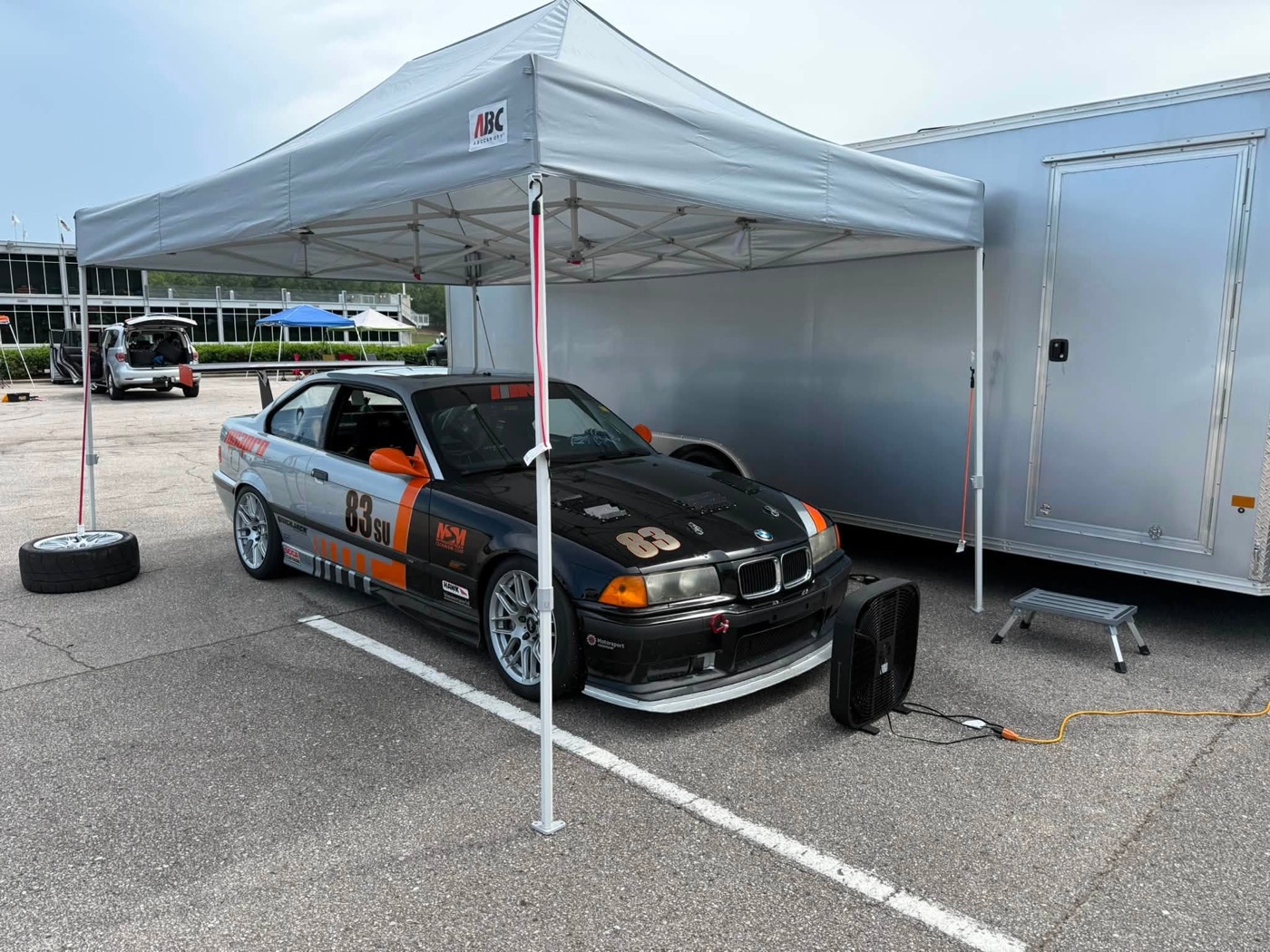 Mike M.'s E36 M3, #83 SU, under the canopy in the Barber paddock