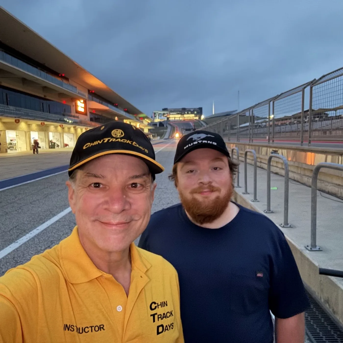 Zach and me on the COTA pit straight at dawn, me in my Chin Track Days instructor shirt