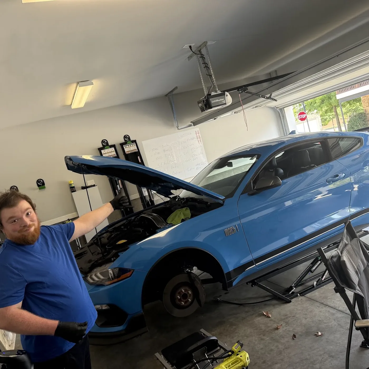 Zach with the Mach 1 on the lift at home, hood up