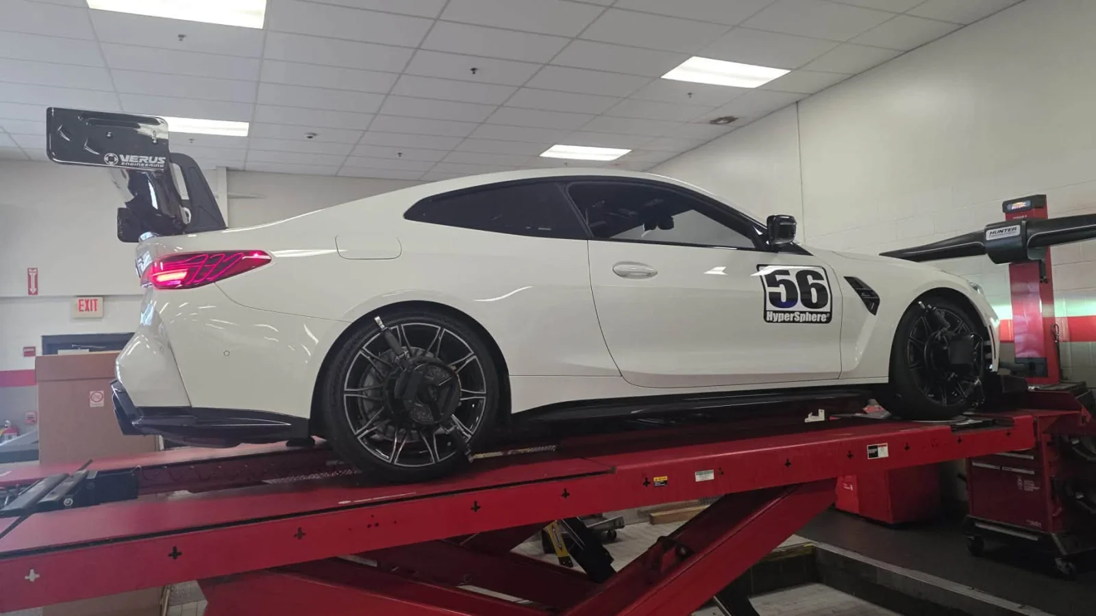 The #56 M4 on an alignment rack, VERUS rear wing raised, HyperSphere door number