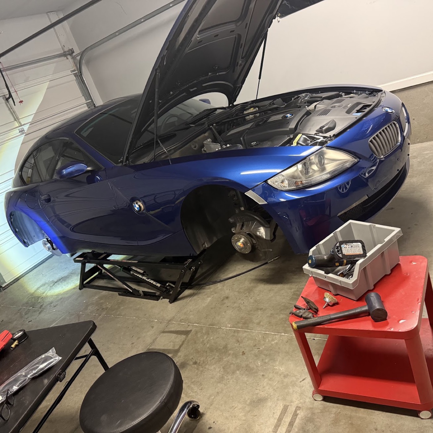 The E86 up on the QuickJack, front wheel off, hub and brake exposed