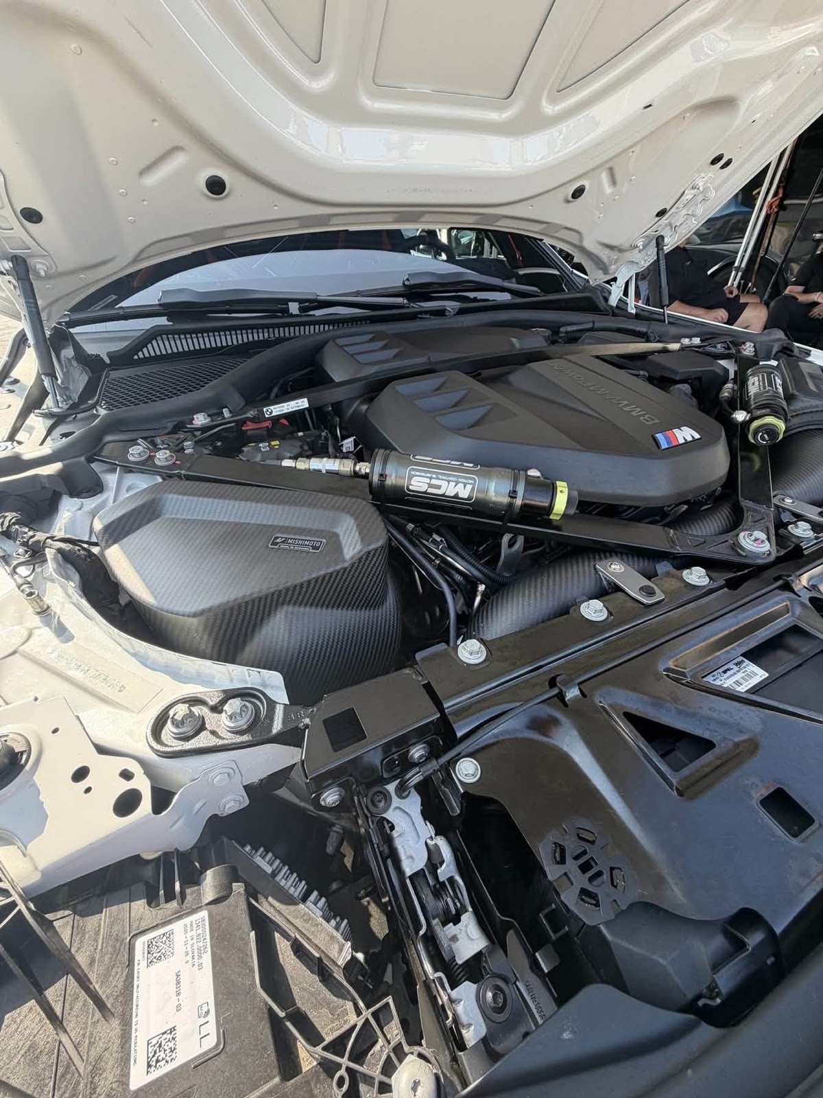 Engine bay with BMW S58 M engine, MCS suspension reservoir and Mishimoto cooling