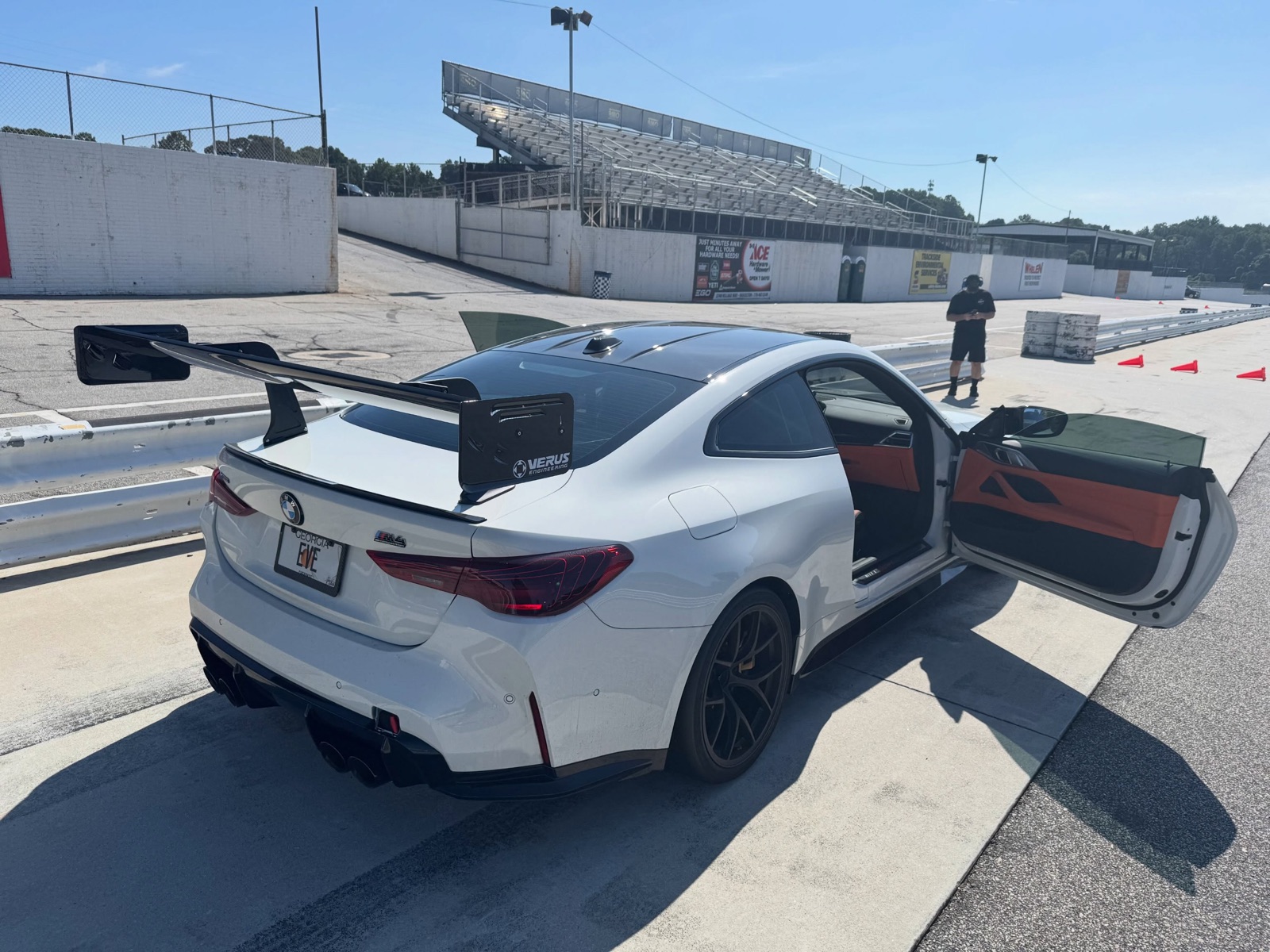 Front three-quarter of the #56 M4 with VERUS front splitter in pit lane at Road Atlanta