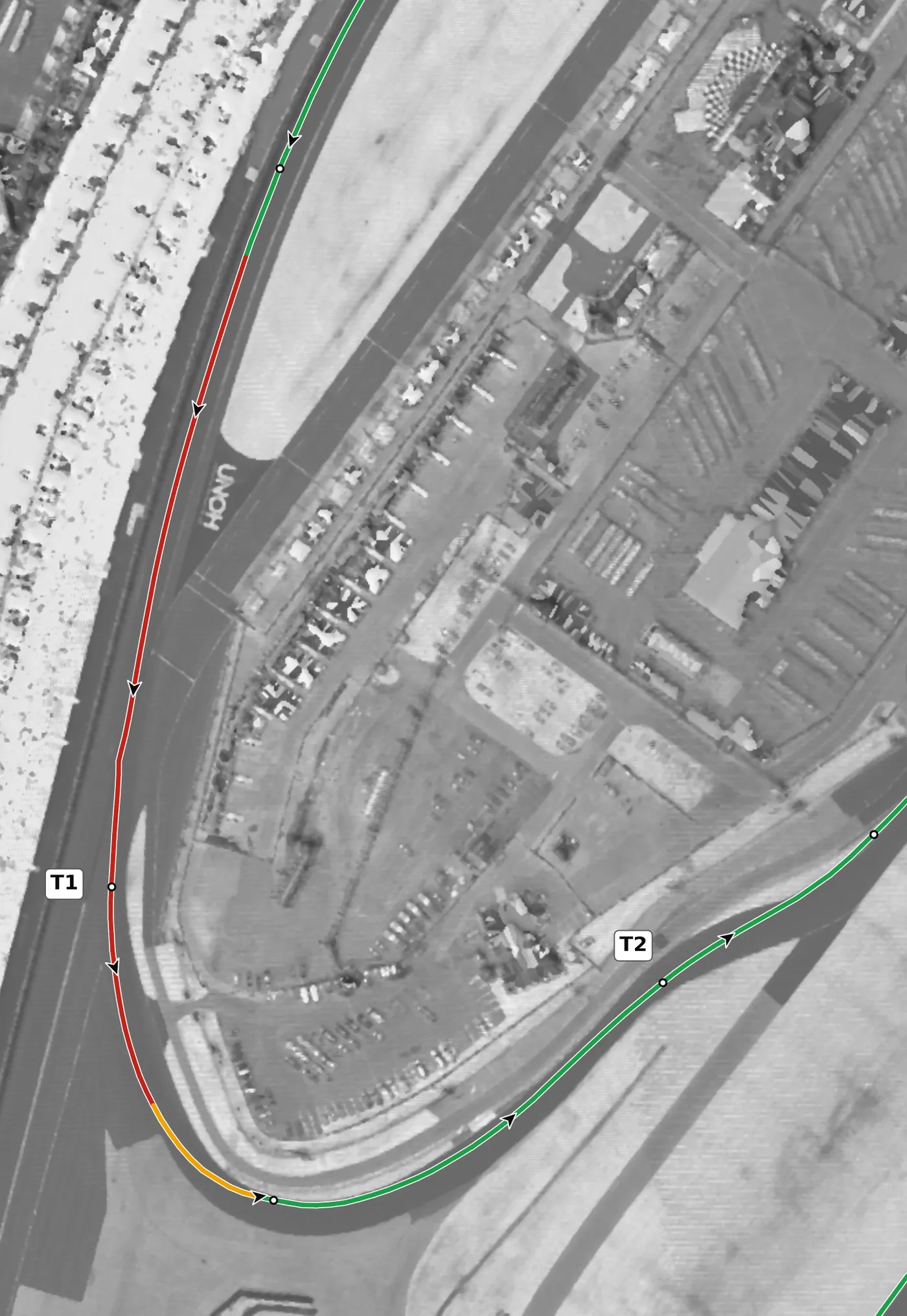 Daytona (road course) T1 race line close-up: Off the 18° tri-oval onto a flat infield: camber falls from +1.6% to about zero through the turn.