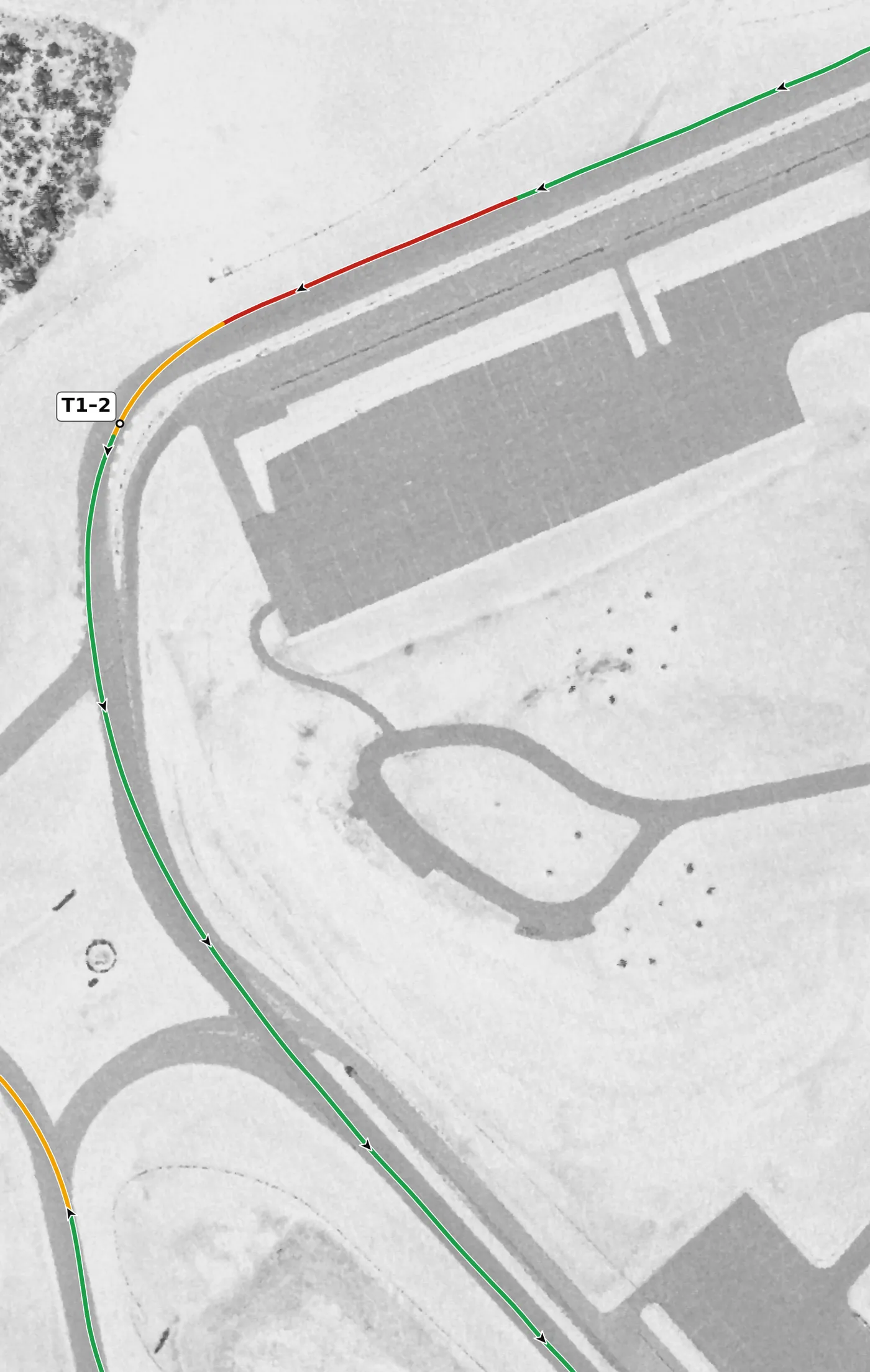 Pitt Race T1–T2 race line close-up: One continuous left that Chin numbers T1 and T2: it drops 2.7 m to the apex and climbs 2.8 m out.